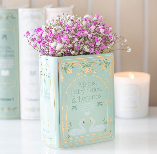 Green ceramic book shaped vase. Sage Green in colour with delicate gold details. Book is freestanding with a hole at the top to add flowers. Part of the book lover flower range