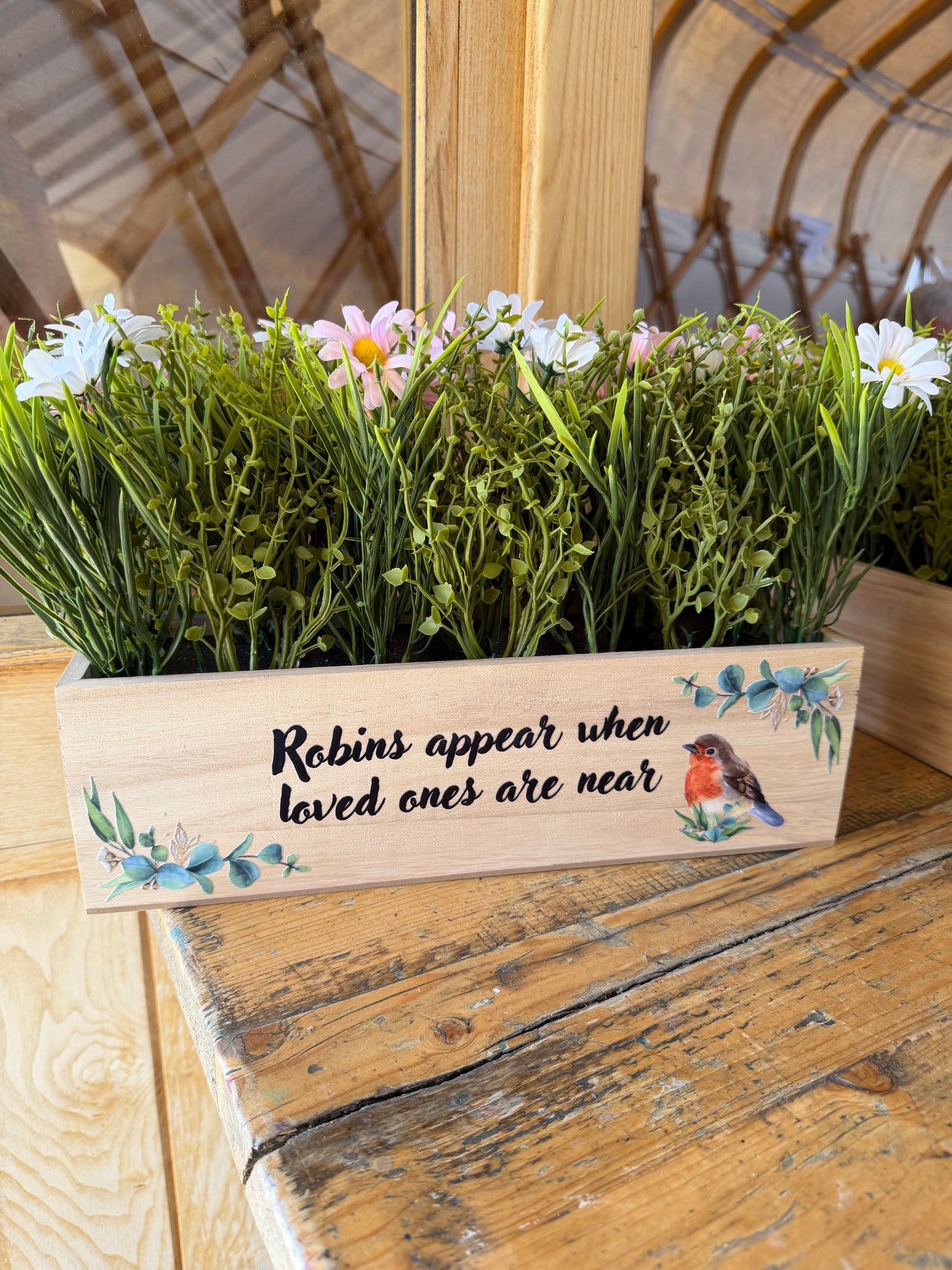 Robins appear when loved ones are near window box with flowers